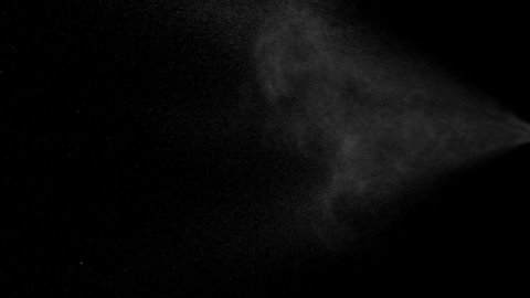 Water spray flowing on black background, slow motion.