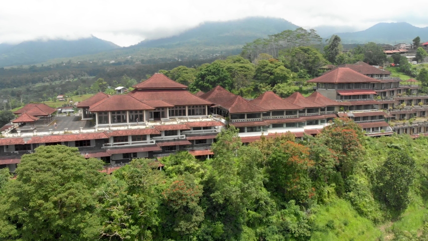 Aerial shot of a beautiful building in the woods.