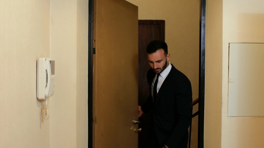 businessman with a beard and suit and tie enters the office door. 4k. 4k video - Powered by Shutterstock - Get 15% off with code: PIKWIZARD15