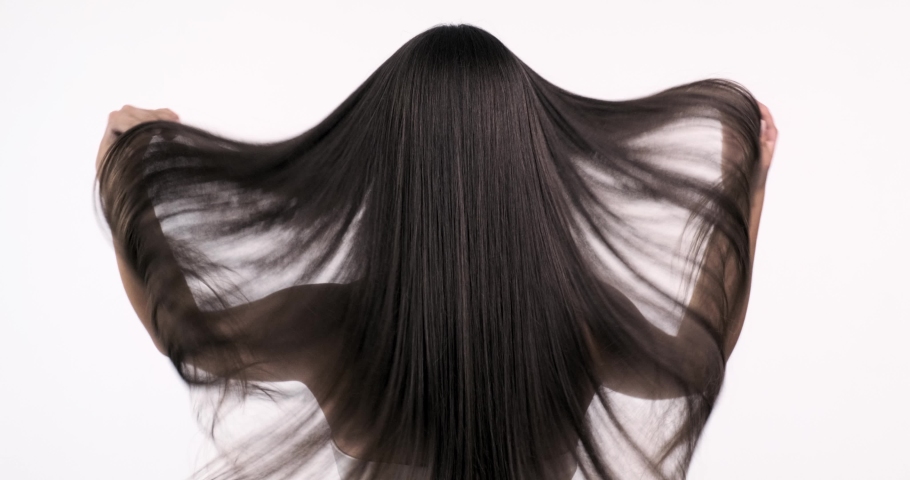 Woman moves long hair. Rear view. Girl shakes long straight hair. Female model is fluttering hair.   Slow motion footage. Rear view. | Shutterstock HD Video #1032804773