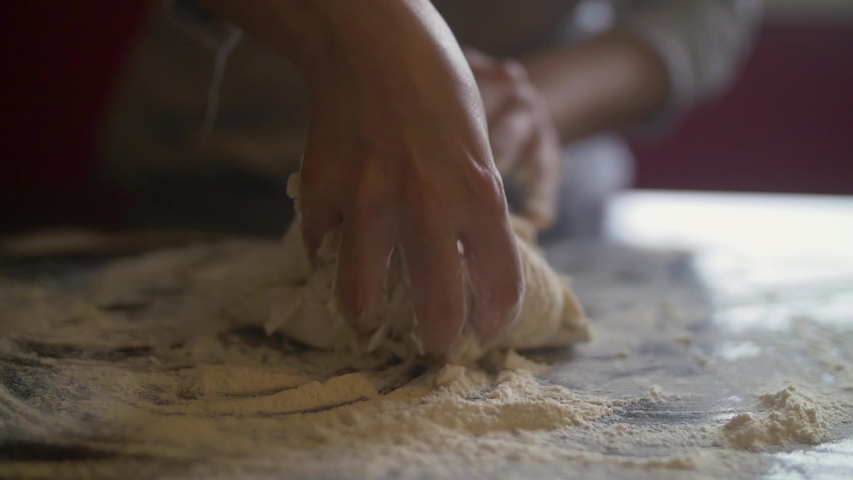 Woman's hands making pizza dough on a marble table full of flour. Slow Motion | Shutterstock HD Video #1032805973