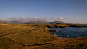 4K Time lapse video of Mullaghmore coastline with Classiebawn castle on the background, cliffs, rocks, mountains and moving waves