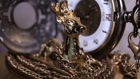 Close Up Of Gold-Colored Souvenir Deer And Vintage Pocket Watch - Powered by Shutterstock - Get 15% off with code: PIKWIZARD15