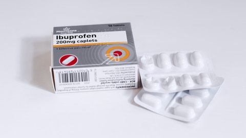London / UK - July 8th 2019 - Box of ibuprofen painkillers and blister pack of tablets coming slowly into focus