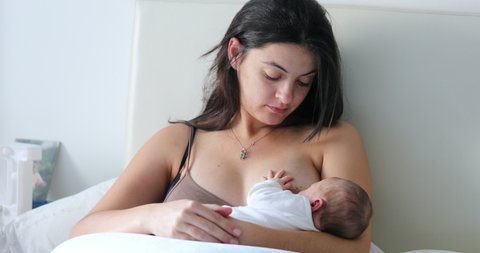 Newborn breastfeeding, mother breastfeeding her newborn baby