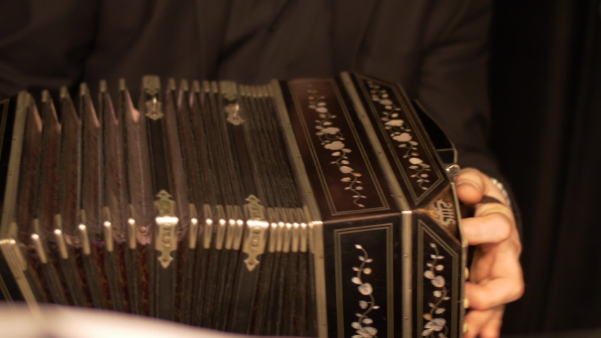 Close-up of a Bandoneon accordion, being played practicing for a tango music show. | Shutterstock HD Video #1032852707