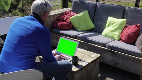 Green screen copy space chroma key on laptop display with working man.
