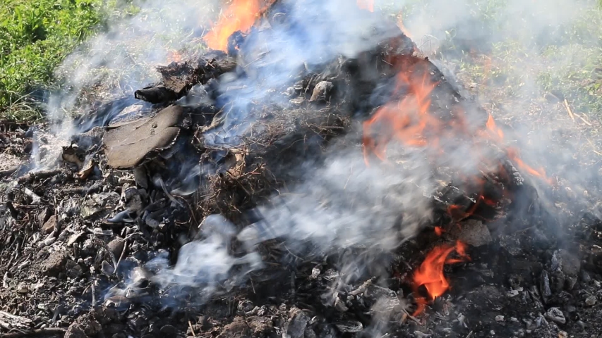 Burning and smoking mountain of garbage. Ecology pollution. | Shutterstock HD Video #1032856859