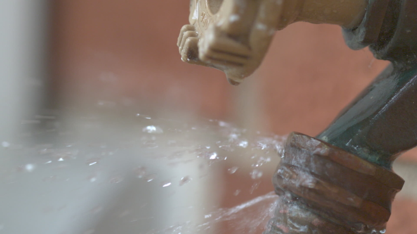 Leaking hose connection water spraying slow motion | Shutterstock HD Video #1032857150