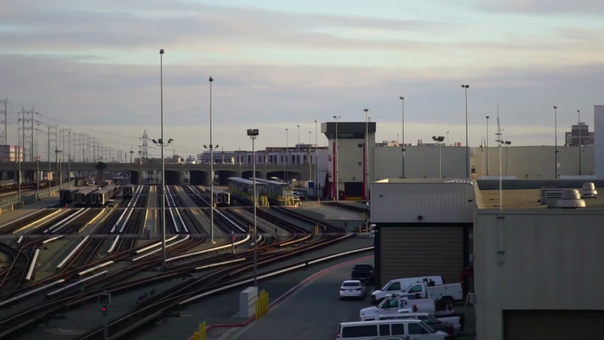 Dolly gliding view of Los Angeles train depot. Freight trains containers in industrial zone. Concept of urban shipping, fossil energy, freight industry in America.