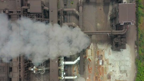 Aerial view. Dirty smoke and smog from pipes of steel factory and blast furnaces.