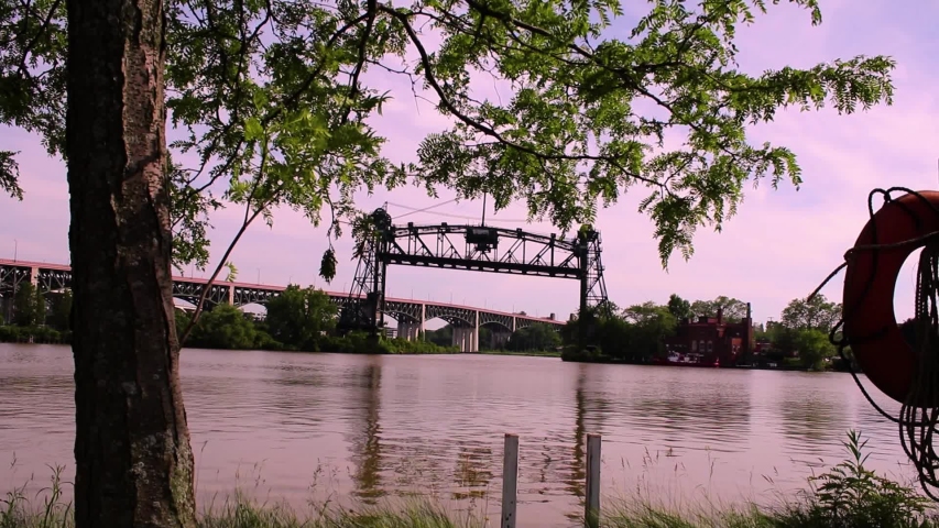The abandoned Eagle Ave Bridge in Cleveland Ohio spans the revitalized Cuyahoga River. Downtown Cleveland overlooking the river with an old bridge in the background.