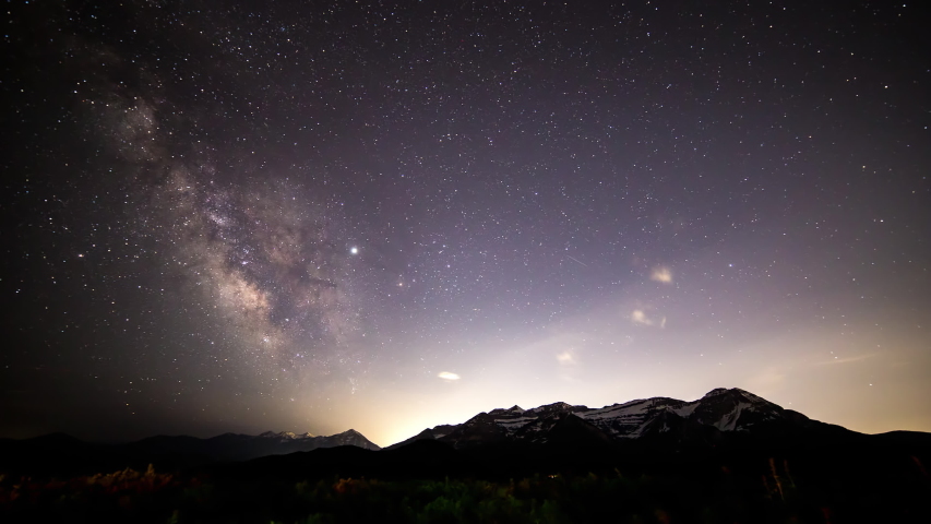 Night to day time lapse of the Milky Way over timpanogos mountain in Utah as the stars move through the sky and sun lights up the mountain peaks. | Shutterstock HD Video #1032868649