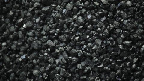 close up of black gravel moving to vibration of a speaker. experimental art footage