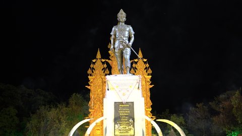 THAILAND, Chiang Rai - MAY 21, 2019: King Mangrai Monument at night with light, smoke and flying bats. King Mangrai is the 25th King of Lanna and the 1st King of Ngoenyang.