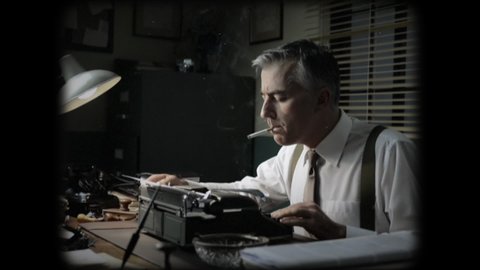 Vintage journalist working late at night at office desk, typing and smoking a cigarette.