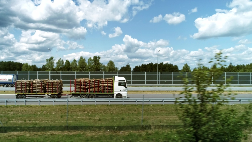 Drone view of truck with log pile in the city 