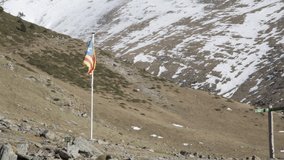 4K clip of the Starry Estelada Catalonia independence flag waving with the wind in the fields on top a snowy mountain in Spain