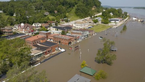 Aerial footage of flood destruction in a small town with disaster relief and sand bagging. 4K footage at high bit rate.