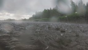 Heavy Rain Drops Falling On The Lake Water Surface. Slow motion