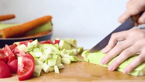 woman is cooking. Women's hands cut vegetables on a cutting board .Video HD