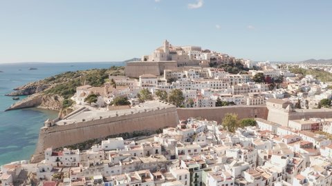 Aerial view of Ibiza city, the Old Town and the city walls of Eivissa, in the island of Ibiza, on a sunny and clear day.