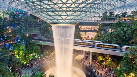 Singapore, Changi Airport, The Jewel Entertainment And Retail Center.  06,16,2019. TL/PU/ZO Pan Up Zoom Out Time lapse with monorail passenger trains passing through, transporting commuters.