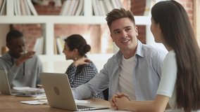 Friendly caucasian male student talking to asian female classmate discuss school project, diverse girl and guy share ideas study together communicating cooperating in classroom sit at desk in library - Powered by Shutterstock - Get 15% off with code: PIKWIZARD15