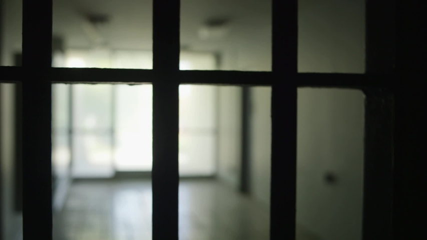 Prison gate closing in front of window. Royalty-Free Stock Footage #1032911333