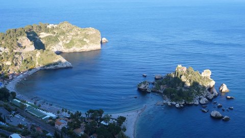High angle view from hilltop of small Isola Bella island and Taormina town beach on Ionian sea seaside