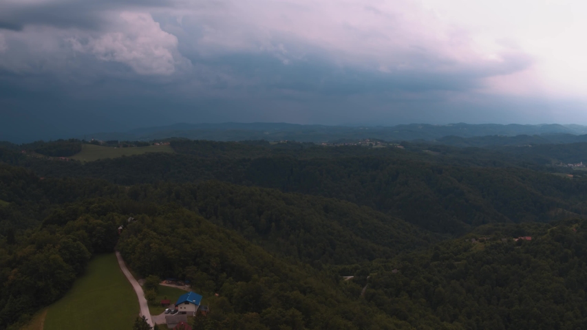 big clouds of rain over forest RAW