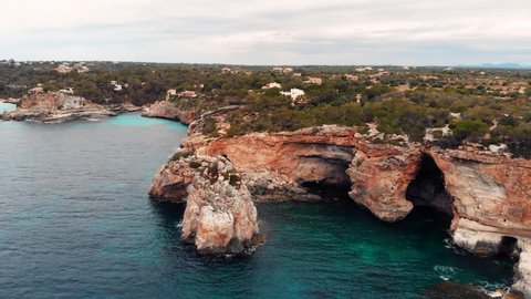 High aerial view overlooking the famous Es Pontas natural arch and the eroded coastline on the island of Majorca