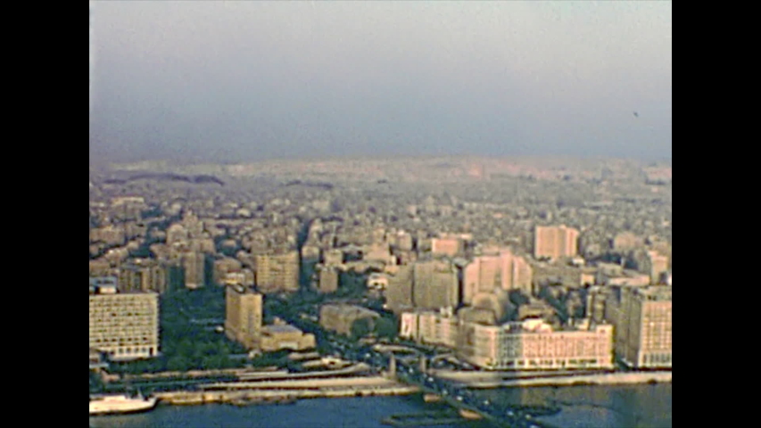 Aerial view panorama of the Cairo streets and Qasr Al-Nil square and Qasr al-Nil Bridge. City traffic with vintage cars and buses. Archival from Cairo tower of Egypt in the 1970s.