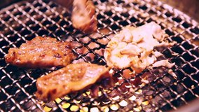 Chinese BBQ, beef and seafood on the grill with flames in restaurant.
