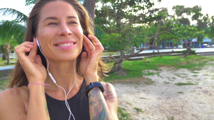 Woman  listening to music in headphones from smart phone mp3 player