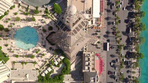 Aerial flight over quay street at Las Vegas. View on luxury hotels, swimming pool with tourists, casinos, and emerald water. The Strip. Las Vegas. Nevada. Jul 2019.