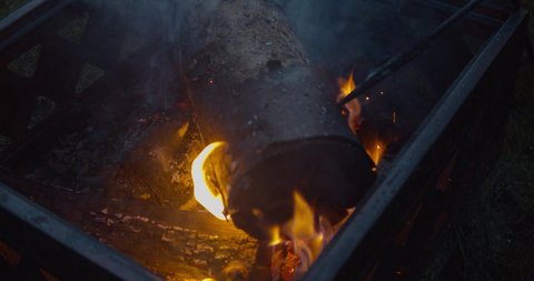Slow motion footage of camp fire being stoked. 4K footage at high bit rate.