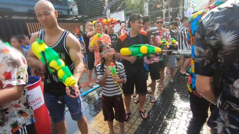 Bangkok, Thailand-April 14, 2019: Locals and tourists celebrate Songkran Festival, Traditional Thai New Year. People play water, and use water guns to enjoy the festival.