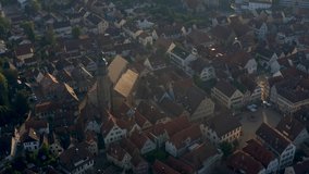 Aerial of the old part of town from Vaihingen an der Enz in Germany.  Camera tilts down and zooms in over the marketplace and city church, rotates left and tilts up to Kaltenstein Castle.