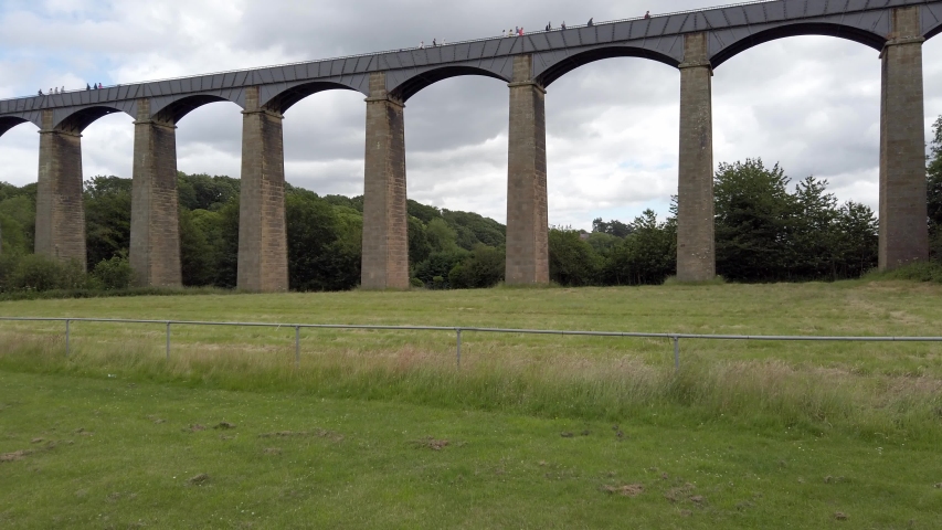 Pontcysyllte Aqueduct Wales waterway Llangollen canal crossing the river Dee valley low aerial push in view.