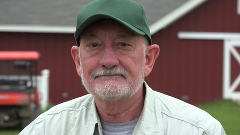 Farmer in front of his barn, close up portrait