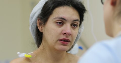 Tired Patient woman speaking to doctor at hospital feeling pain