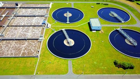 Aerial view of sewage treatment plant. Industrial water treatment for big city from drone view. Flight over waste water management.