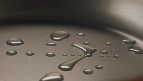 Close-up of chef pouring oil on hot frying pan. Slow motion video