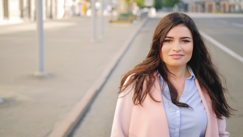 Meeting your date. Happy excited smiling woman running in the street towards viewer