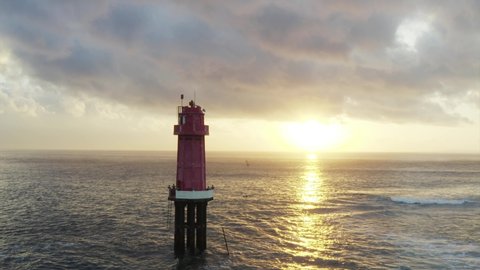 Panoramic aerial view of lighthouse in the ocean at sunrise. Beautiful cloudscape. Bali, Indonesia