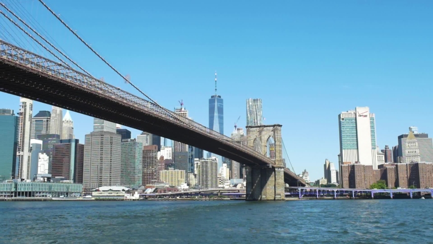 Slow motion looking across East River at Brooklyn Bridge and downtown Manhattan | Shutterstock HD Video #1033012712