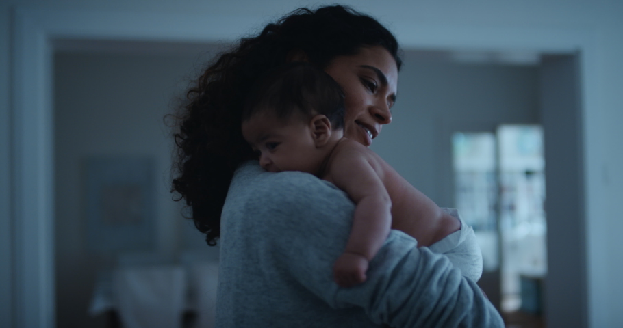 Mother holding baby gently soothing infant calming her newborn child mom caring for toddler at night 4k | Shutterstock HD Video #1033021412