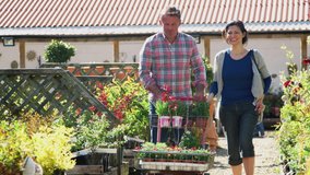 Mature Couple Customer Buying Plants And Putting Them On Trolley In Garden Center - Powered by Shutterstock - Get 15% off with code: PIKWIZARD15