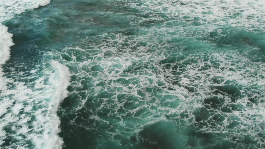 Top view of the Atlantic Ocean, small waves create sea foam near the beach | Shutterstock HD Video #1033022975